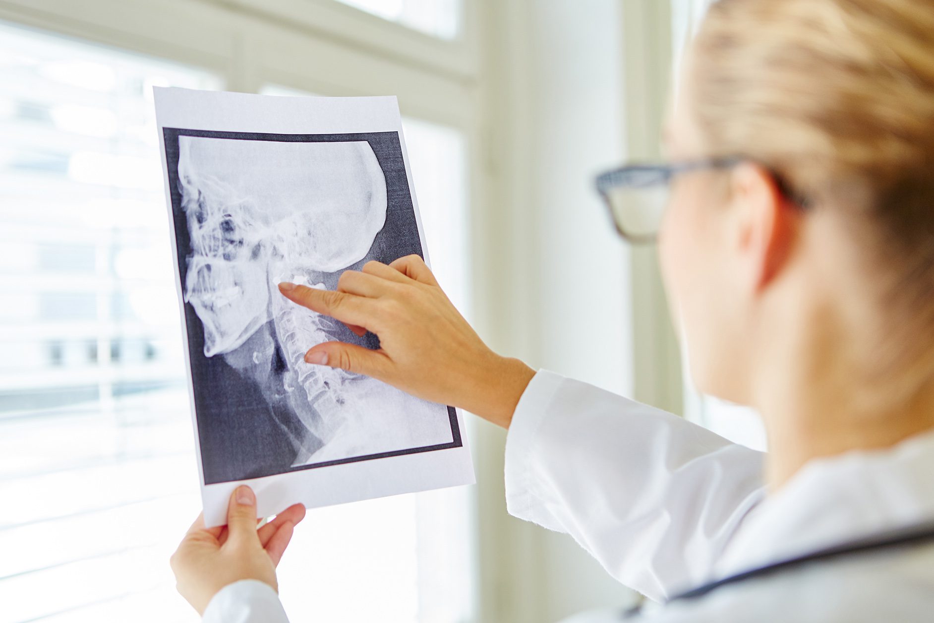 Dentist examining patient xrays