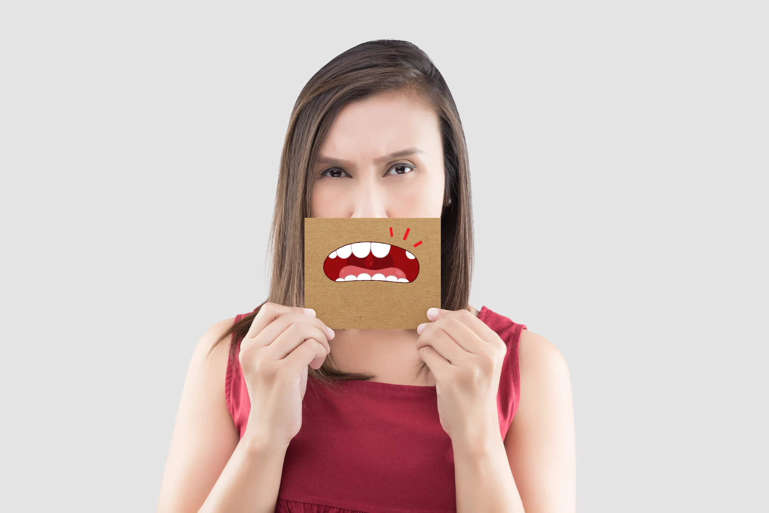 dental patient hiding her missing teeth