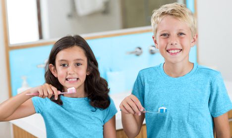 Young dental patients brushing their teeth